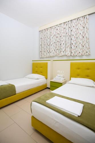 Ліжко або ліжка в номері Vlora Apartaments