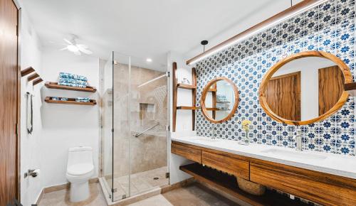 a bathroom with a shower and a toilet and a sink at Pájaro de Fuego 406 in Sayulita