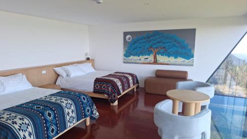 a hotel room with two beds and a window at Ncielo Adventure Lodge in Quito