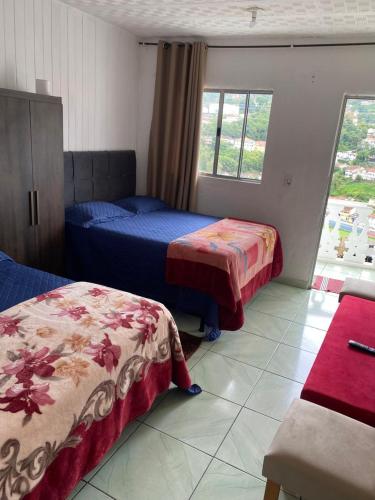 En eller flere senge i et værelse på Kitnet aconchegante