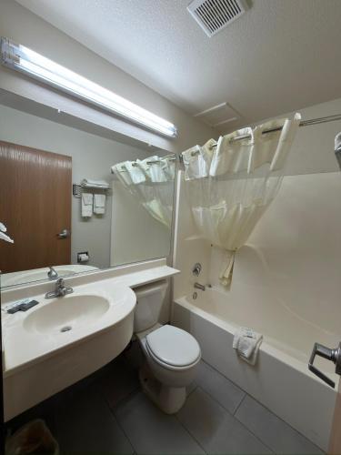 a bathroom with a sink and a toilet and a tub at Americas Best Value Inn and Suites Ada in Ada