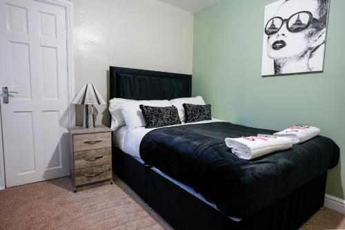 a bedroom with a bed with glasses on it at Victory House in Gretna