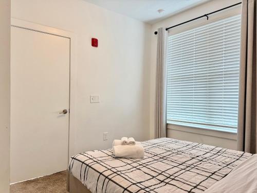 a bedroom with a bed with a towel on it at Modern 4B3B 2 Balcony Penthouse 542Blvd404 in Atlanta