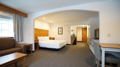 a hotel room with a bed and a couch at Icicle Village Resort in Leavenworth