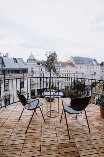 a patio with two chairs and a table on a building at Florum Hotel in Vienna