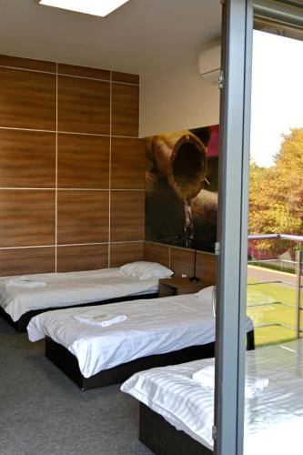 a room with two beds and a painting on the wall at Jordaszka in Wodzisław Śląski
