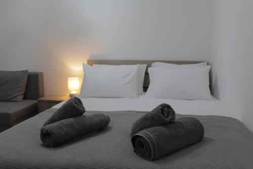 a bed with two rolled up towels on it at La Casa in Kozani