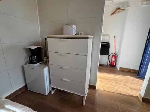 a white dresser in a room with a room with aermottermott at Quarto Santo António in Zambujeira do Mar