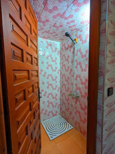 a bathroom with a shower with a zebra shower curtain at The Guests Haven House - Heart Of Skoura in Skoura