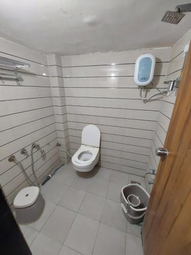 a bathroom with a toilet and a sink at SOU Mahadev Homestay in Garudeshwar