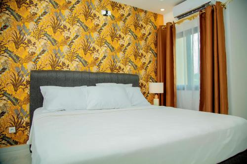 En eller flere senge i et værelse på Résidence Hôtel Missikewa Cocody-Angré