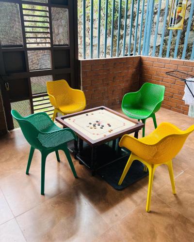 a ping pong table with four chairs around it at Kalon Elpis Villa in Ooty