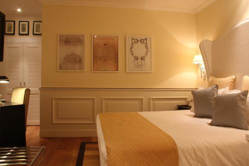 a hotel room with a bed and some pictures on the wall at Hotel Bologna ***S in Verona