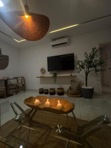 a living room with a table and a tv at ORY luxury garden in Abidjan