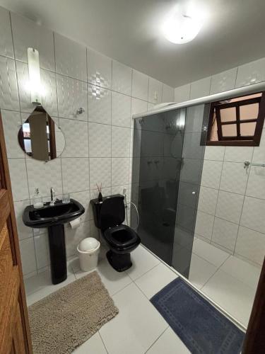 a bathroom with a toilet and a sink and a shower at Morada Alecrim in Diamantina