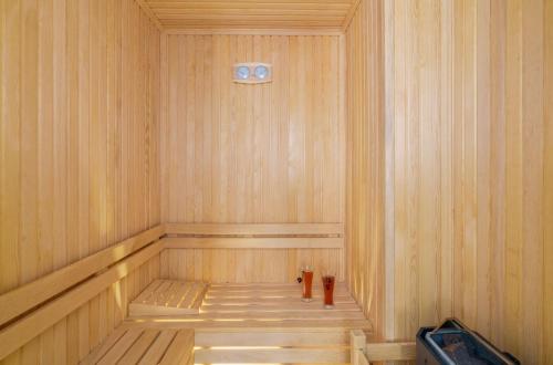 a small wooden sauna with a timer on the wall at Villa Safi in İslâmlar