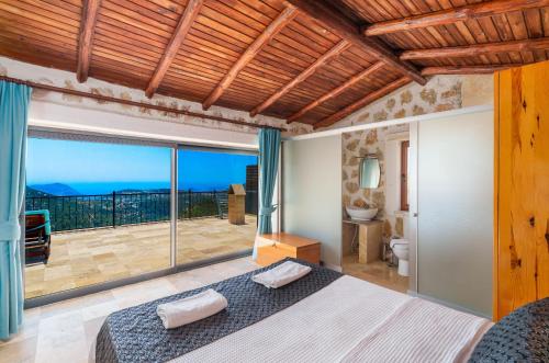 a bedroom with a large bed and a balcony at Villa Safi in İslâmlar