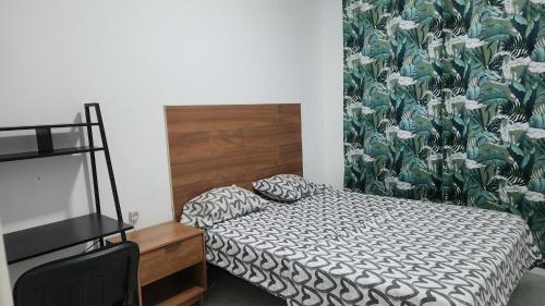 a bedroom with a bed and a flowery wallpaper at Meeting Point Hostels-Praia Beachwalk-NO CASH ACCEPTED-Also in Fogo & Tarrafal in Praia