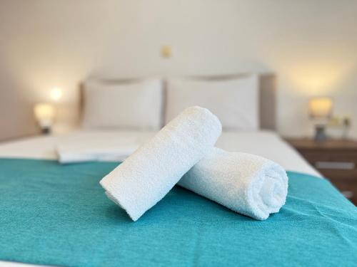 two rolls of toilet paper on a bed at Dimado Family in Kavála