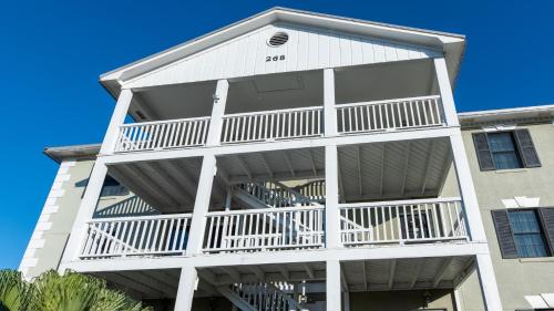 a white apartment building with balconies on it at Captains House A3 in Fernandina Beach