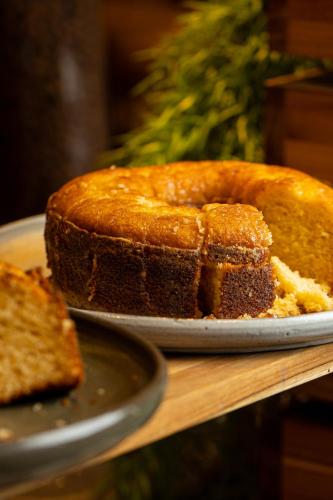a piece of cake on a plate on a table at Nobile Inn London Anápolis in Anápolis
