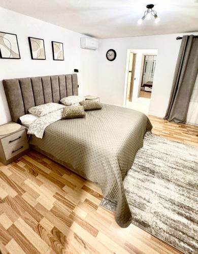 a bedroom with a large bed with a rug at Camera Family Suceava in Ipoteşti