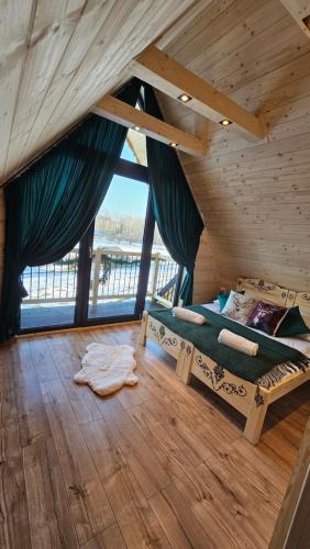 a bedroom with a bed in a wooden house at Domki góralskie Cisza Leśna in Czerwienne