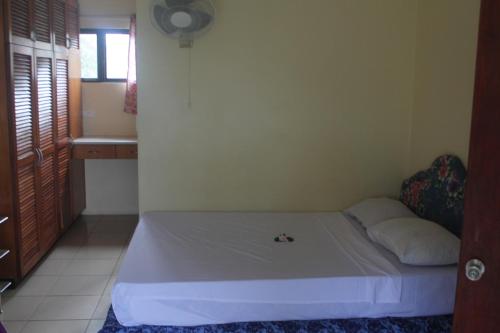 a small bedroom with a bed in a room at Shalini Garden Hotel & Apartments in Singatoka