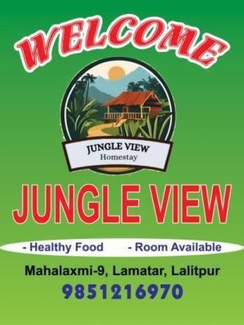 Un cartel para una vista de jingle con una casa en Jungle View Homestay, en Pātan