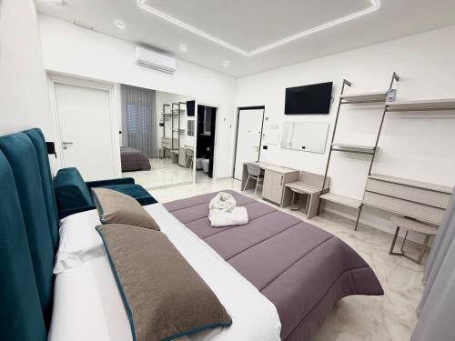 a bedroom with a bed and a living room at D'ANNUNZIO suites in Martinsicuro