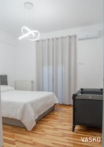 a bedroom with a bed and a window with curtains at VASKO Luxury Suites 3 in Siátista