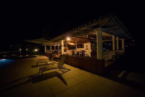 a couple of chairs on a patio at night at Hotel Boutique El Triángulo in Armenia