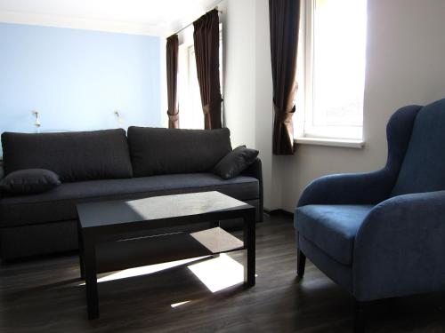 a living room with a couch and a table at Hostel Wratislavia in Wrocław