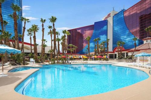 a large swimming pool in front of a hotel at Masquerade Tower at Rio Hotel & Casino by Suiteness in Las Vegas