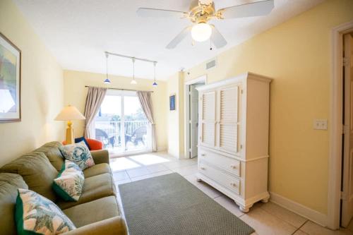 a living room with a couch and a ceiling fan at The Terraces #202-Condo - Pool in Fernandina Beach
