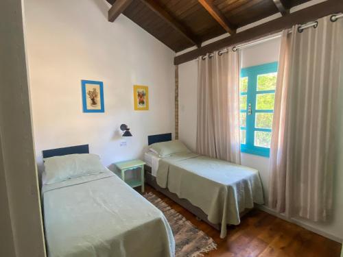 En eller flere senge i et værelse på O Costão do Sol