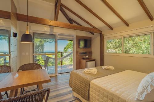 En eller flere senge i et værelse på Hospedaria das Brisas