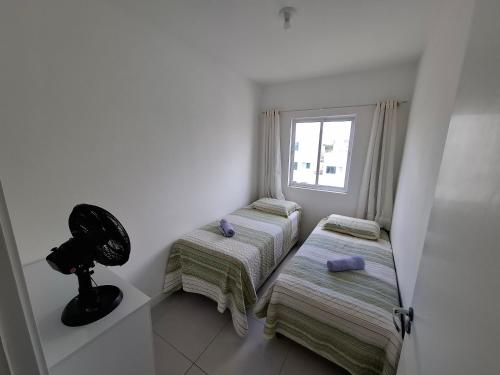 En eller flere senge i et værelse på Conforto e Mar em Navegantes SC