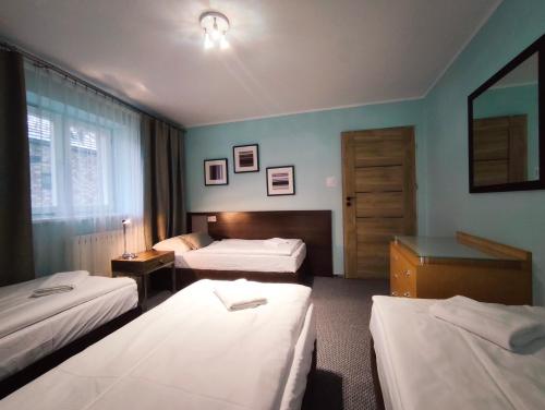 En eller flere senge i et værelse på Domki OSiR - centrum, parking