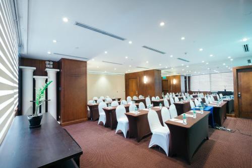 a room with rows of tables and white chairs at City Garden Hotel Makati in Manila