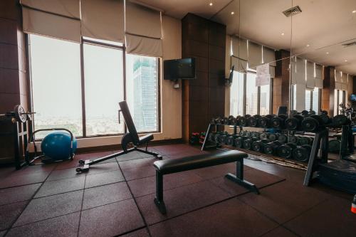 a room with a gym with a lot of weights at City Garden Hotel Makati in Manila