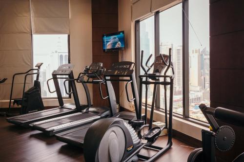 a gym with two tread machines and a large window at City Garden Hotel Makati in Manila