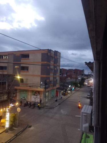 an empty city street at night with a building at Apto central 3 hab in Apartadó