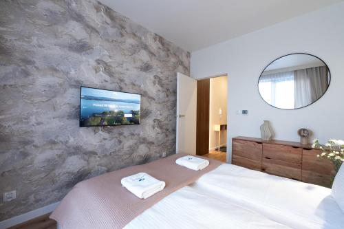 a bedroom with a bed with a tv on the wall at Laguna Beskidów Resort - Desert Spring in Zarzecze