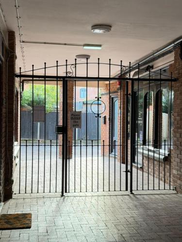 an entrance to a building with a metal gate at 4 Castle Walk in Stansted Mountfitchet