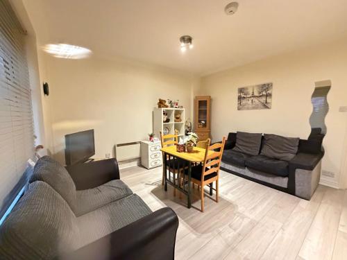 a living room with a couch and a table at 4 Castle Walk in Stansted Mountfitchet