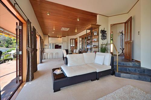 a living room with a couch and a table at The Cliffs - Nelson Waterfront Home in Nelson