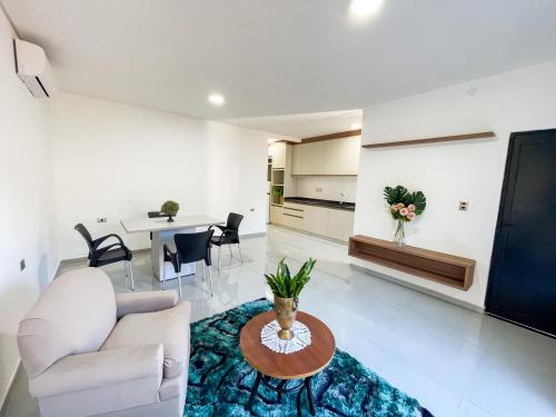 a living room with a couch and a table at A estrenar departamento en la mejor playa in Encarnación