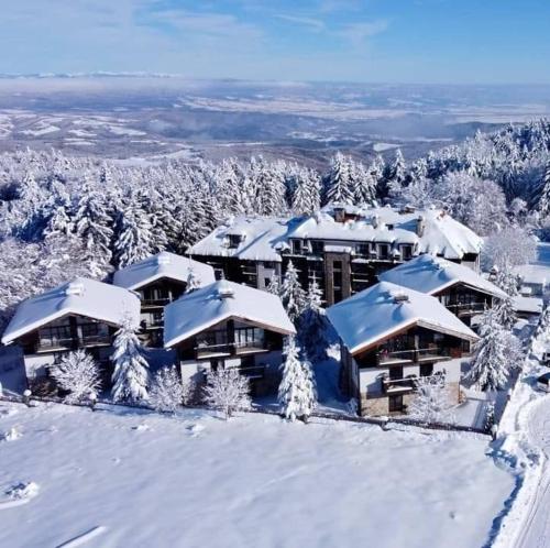a resort in the snow with snow covered roofs at Luxury Chalet in Borovets, Rila Views & Fireplace in Borovets