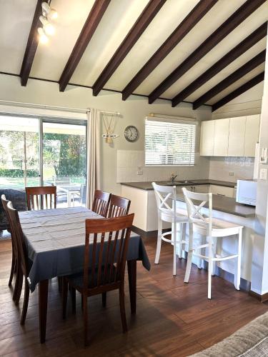 a kitchen and dining room with a table and chairs at Stouty's at Hat Head - No Sheets or Towels Provided in Hat Head